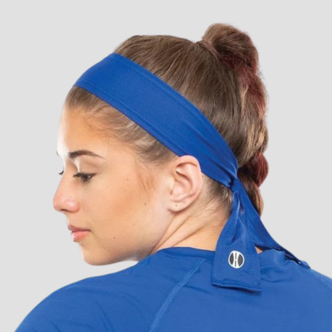 sideview of woman wearing a blue headband and blue tshirt