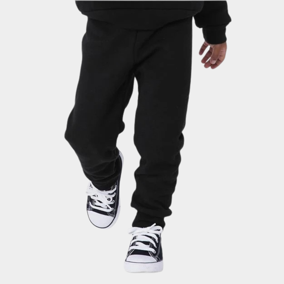 bottom half view of child walking in sweatpants