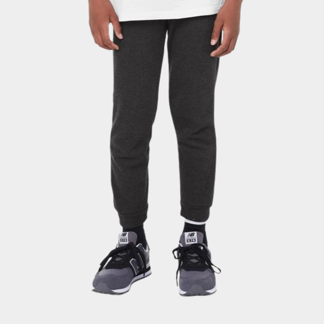 bottom half view of a person wearing black sweatpants and white top