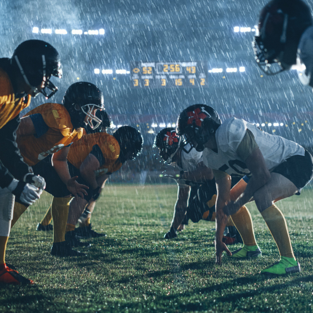 a football team playing football in the rain